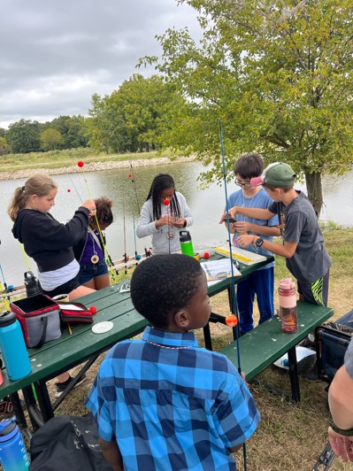 Kids get ready to go fishing near a lake