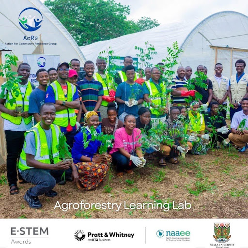 Students, farmers and facilitators hold tree seedlings raised in the Lab nursery, ready for planting on farmland and fire-affected sites in Kori Chiefdom.