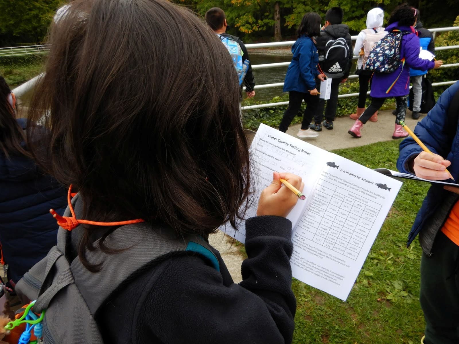 child taking notes outdoors