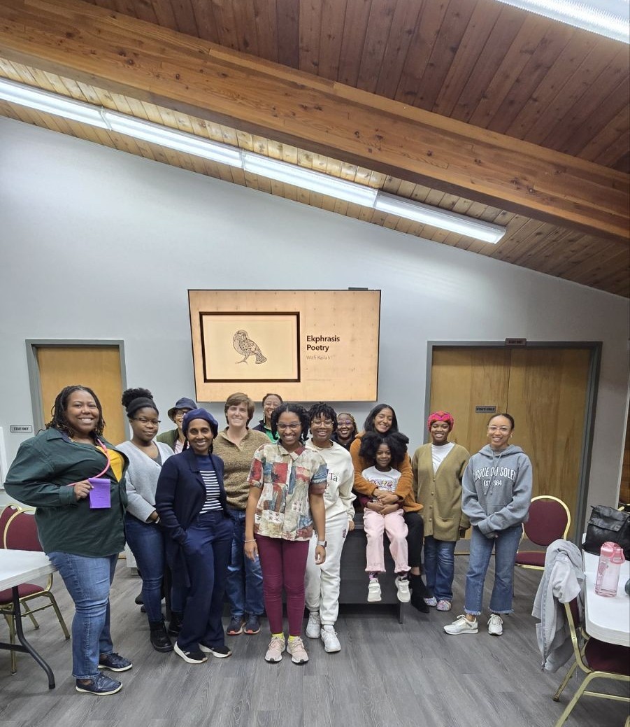 Group inside a building smile at the camera