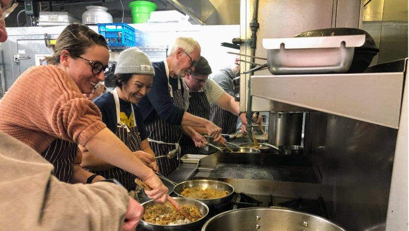 Local teachers and community members join Chef Cara Stadler for a cooking class