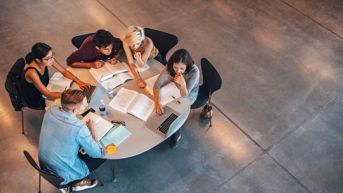 Bird's eye view of a group of college-age students sitting around a round table