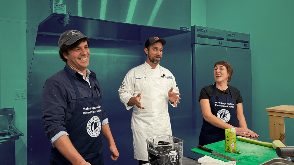 Chef Rob Dumas (center) cracks a joke that has Matt Moretti of Bangs Island Mussels, and Emily of MAIC, laughing while learning to cook Mussels Gratin