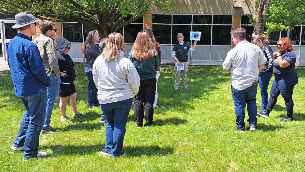 A group of adults participates in an outdoor learning experience. Photo credit: Megan Sharp
