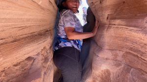 Irina Ayurzanaeva squeezing through the sandstone of Colorado National Monument