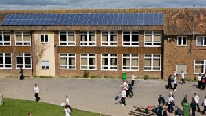 Solar PV panels on the roof above a playground. Photo credit: Andy Aitchinson / Ashden