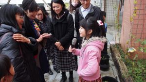 Young girl presenting to a group outdoors