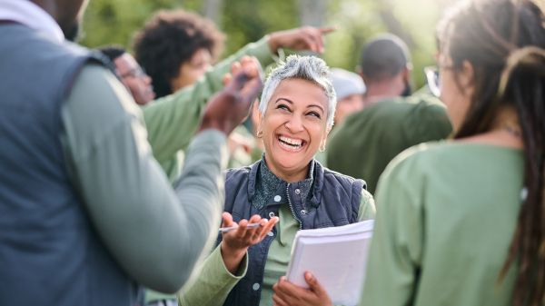Woman with a clipboard talks to two people