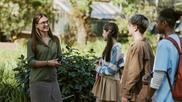 A teacher and three students outside