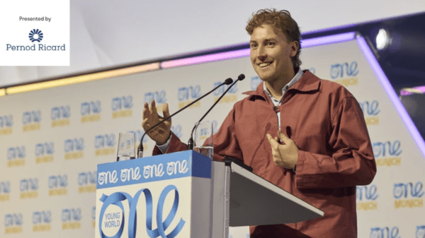 A banner showing a man speaking on a podium