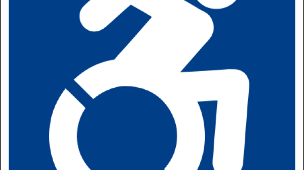 Image of a person self-propelling their wheelchair 