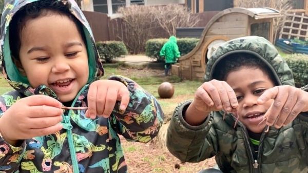 two children holding earthworms