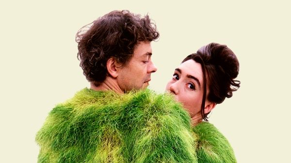 Ackroyd & Harvey: The Art of Activism poster with the two artists close to one another in a large, fuzzy, green costume