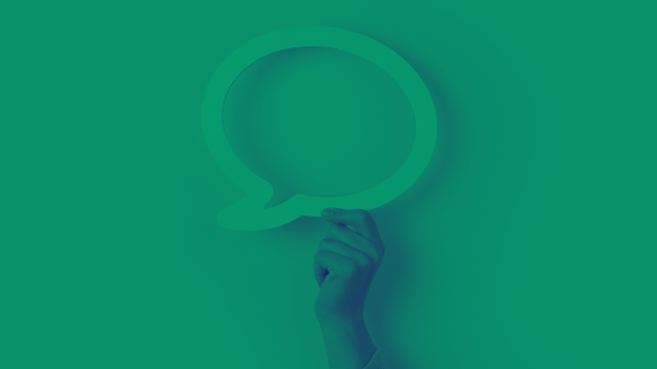 A green-tinted hand holds the shape of a speech bubble