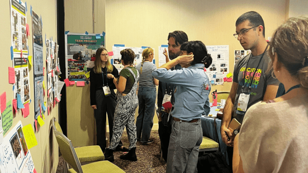 CEE-Change Workshop Gallery Walk A group of NAAAEE 2024 attendees look at posters at the CEE-Change Workshop gallery walk