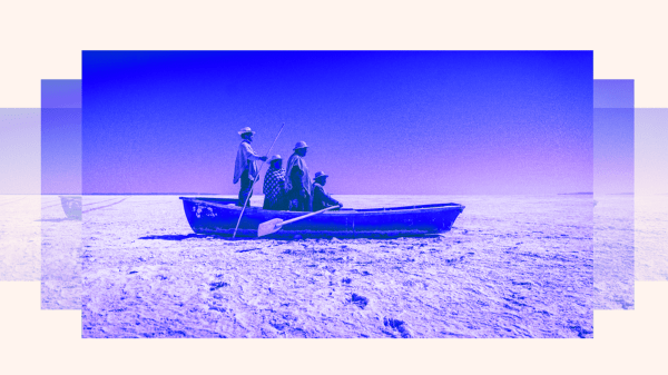 Purple tinted boat with four people aboard in a desert