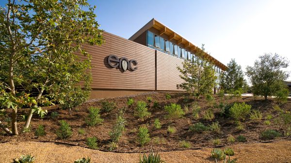 A view of the Environmental Nature Center. A building on a sunny day. The letters "enc" are posted on the building. Landscaping with desertous plants in front.