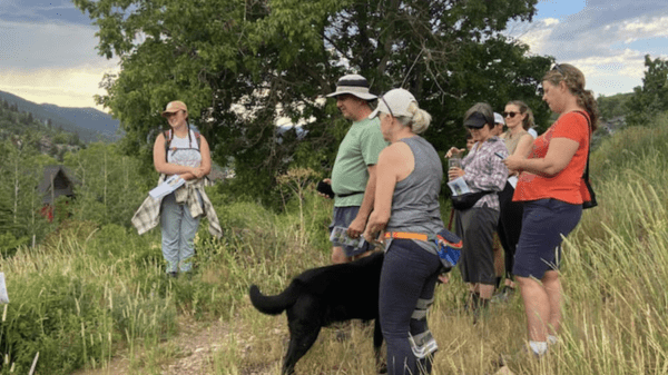 Tessa Scheuer educating Summit County Land Conservancy visitors along a trail.