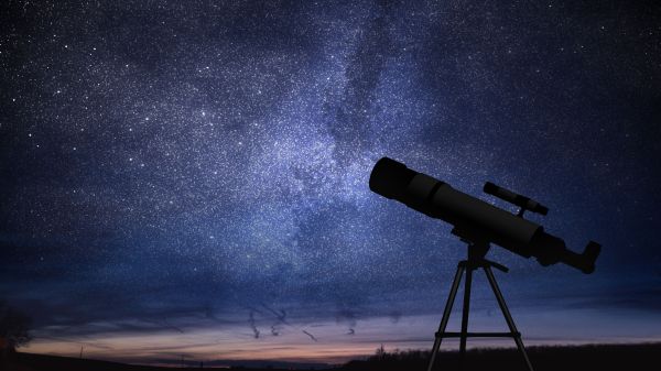 Telescope against a backdrop of a plethora of stars amidst midnight blue