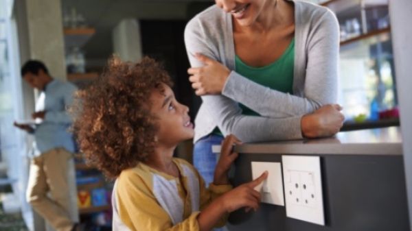 Woman and child looking at electrical outlets 