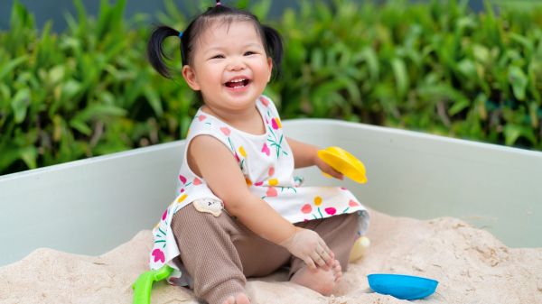 baby girl in sandbox
