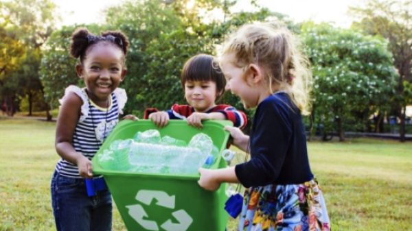 Three children recycling