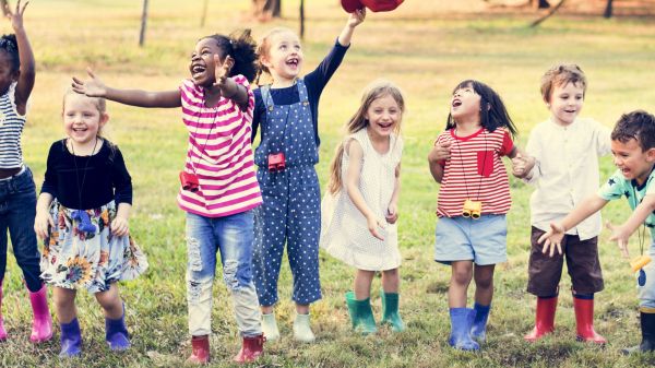 Dodge Nature Preschool Learning Conference A group of children line up outdoors with a green field behind them