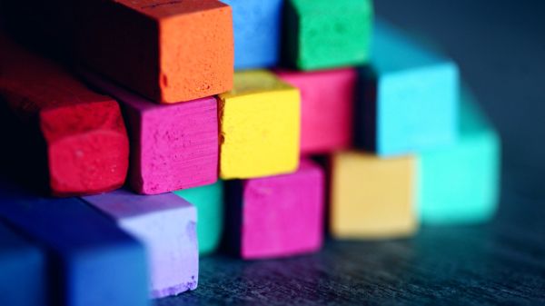 Colorful pastel crayons stacked on top of each other