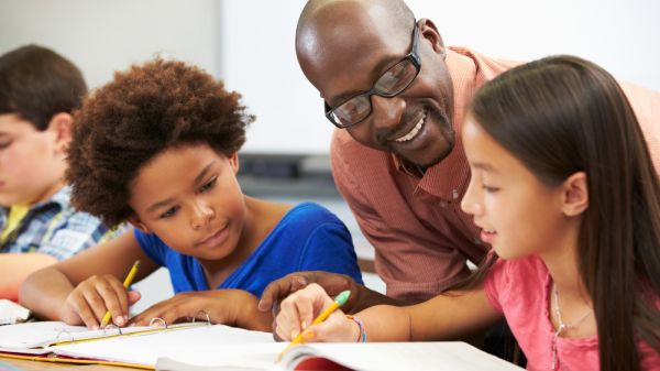 Teacher and students in group study (multiethnic)