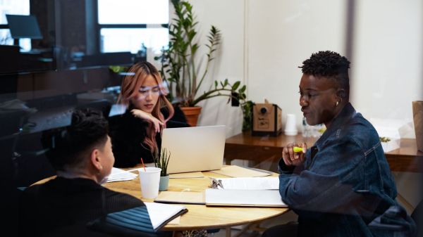 A group of co-workers of varying genders having a meeting
