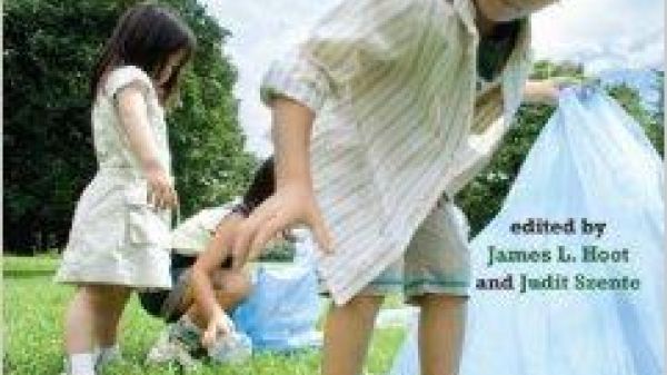 Book cover showing children picking up plastic water bottles