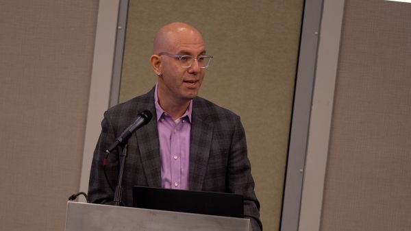 Dr. Levy standing at a podium