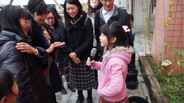 Young girl presenting to a group outdoors