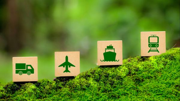 Climate Change and Transportation Four blocks sit on a mossy incline; the first features an image of a truck, the second a plane, the third a boat, and the fourth a tram.