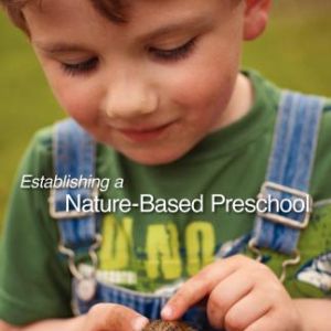 A child in overalls holds a toad