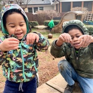 two children holding earthworms