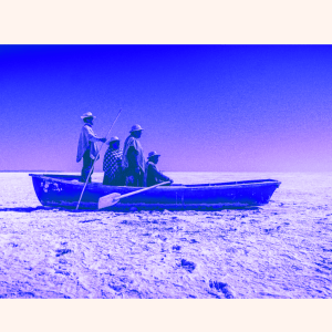Purple tinted boat with four people aboard in a desert