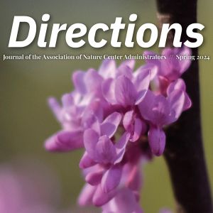 A pink redbud flower emerges from a branch. Above, the text "Directions."