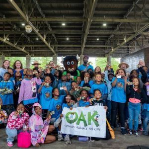 A class of 4th graders gather for a group photo to celebrate the Every Kid Outdoors Program with mascot, Buddy the Bison, and other local leaders and national champions of the EKO program at an event in Anacostia Park sponsored by OAK.