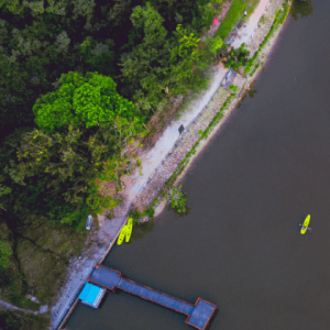 An aerial view of a river with bright yellow canoes 