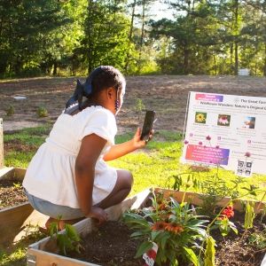 Young student with wildflower garden project