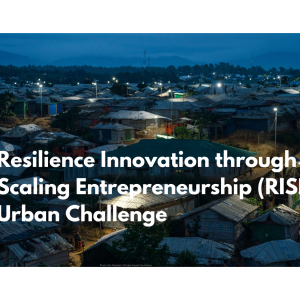 Text on an image of a crowded urban settlement at night: "Resilience Innovation through Scaling Entrepreneurship (RISE) Urban Challenge".