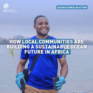 A man holder tree seedling in front of a body of water