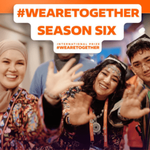 A banner announcing the 2026 We are Together Prize showing volunteers waving and smiling