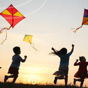 Text reads, "Webinar Youth Outdoor Policy Trends: What's Working & What's Next Monday, May 11 | 3:00 PM ET" accompanied by an image of children play with and chasing kites through a field at sunset