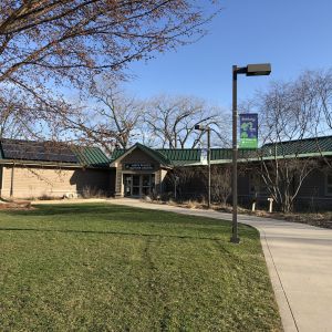 The entrance to Anita Purves Nature Center, where solar panels sit atop the building.