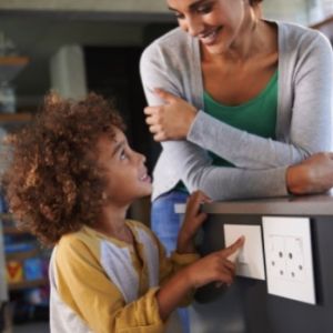 Woman and child looking at electrical outlets 