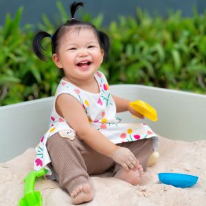 baby girl in sandbox