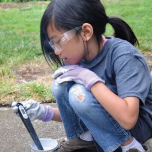 Young student testing water outdoors