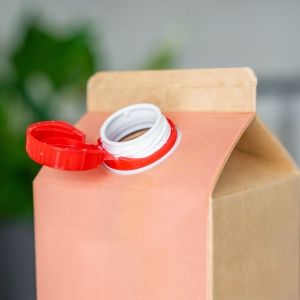 A red carton with an open lid, a blurred room background behind it.